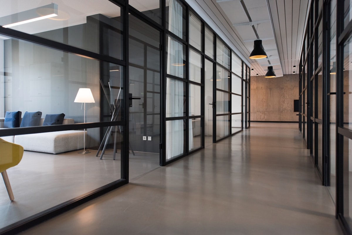 A calm modern workspace with laptops and a team table